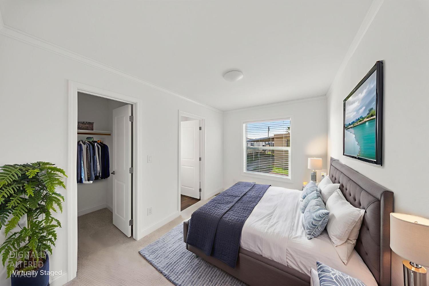 2030 East Grayson Road, Unit 44 Ceres, CA 95307 - Photo 18 of 20 a bedroom with a bed and a flat screen tv