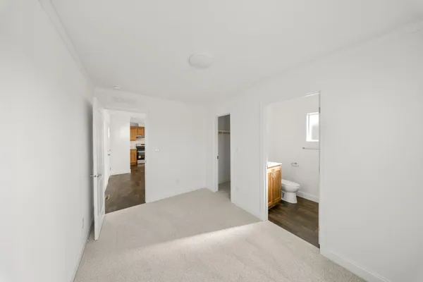 a spacious bedroom with a bed and toilet