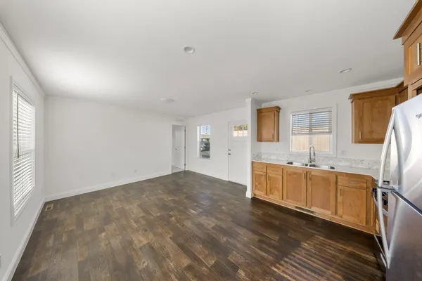 a kitchen with stainless steel appliances granite countertop a stove a sink and a refrigerator