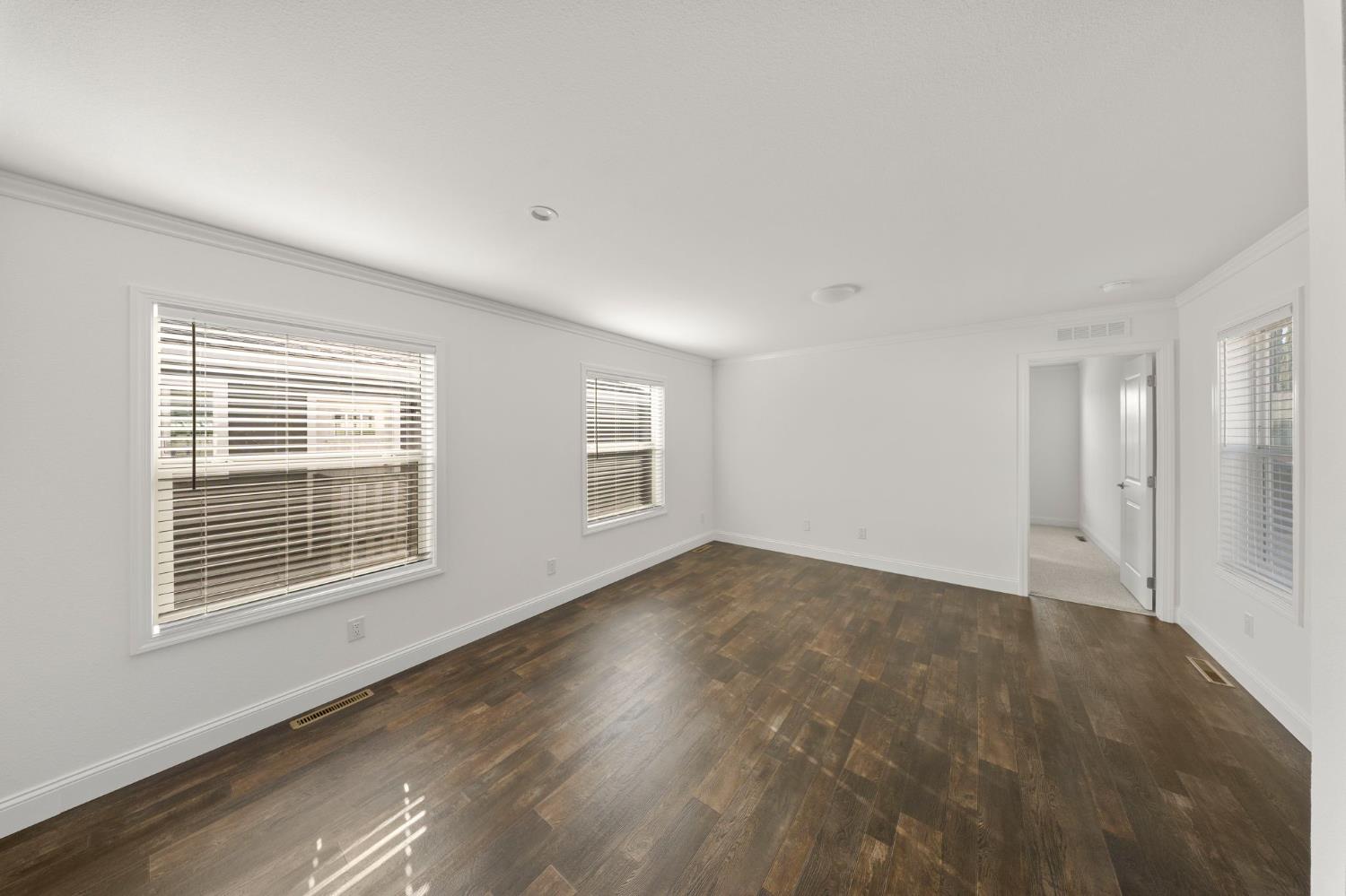 2030 East Grayson Road, Unit 44 Ceres, CA 95307 - Photo 6 of 20 a view of an empty room with wooden floor and a window