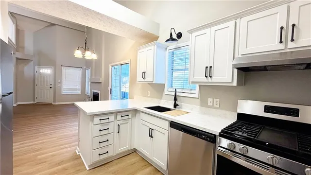 a kitchen with granite countertop a stove and a sink