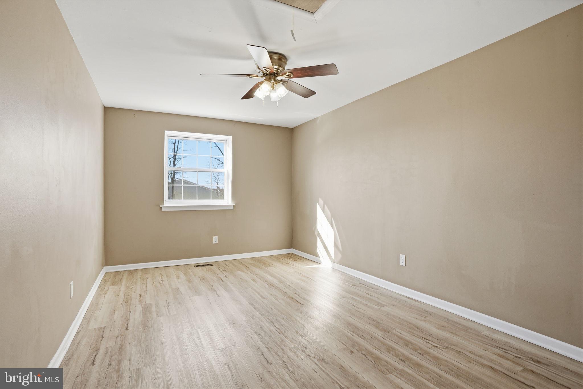 12135 Academy Road, Unit 42 Philadelphia, PA 19154 - Photo 11 of 18 an empty room with wooden floor chandelier fan and windows