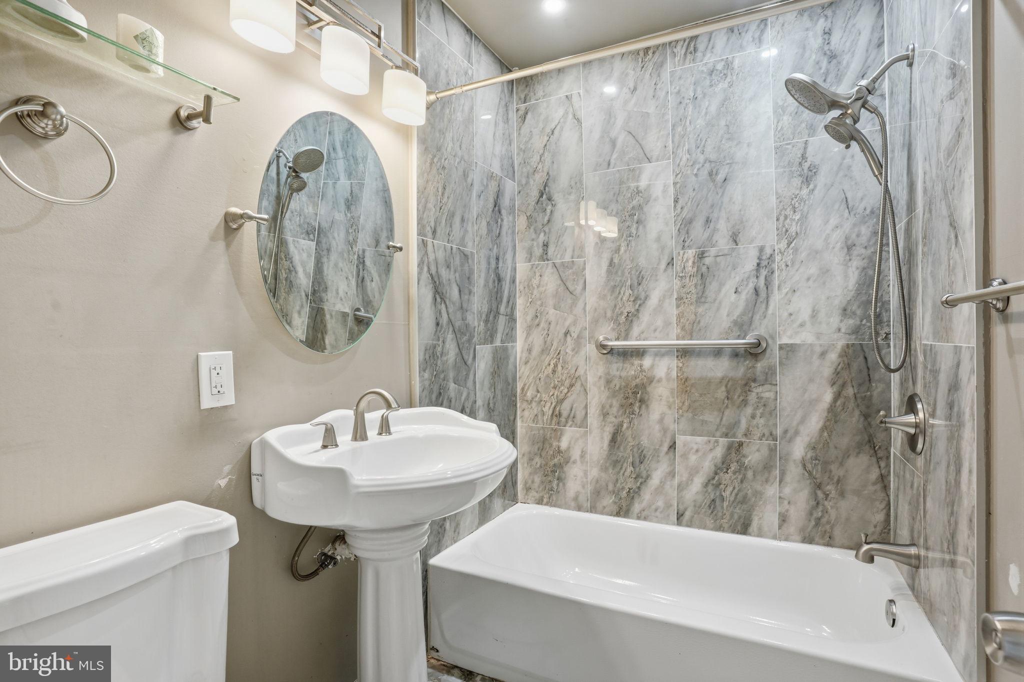 12135 Academy Road, Unit 42 Philadelphia, PA 19154 - Photo 15 of 18 a bathroom with a sink a toilet and shower