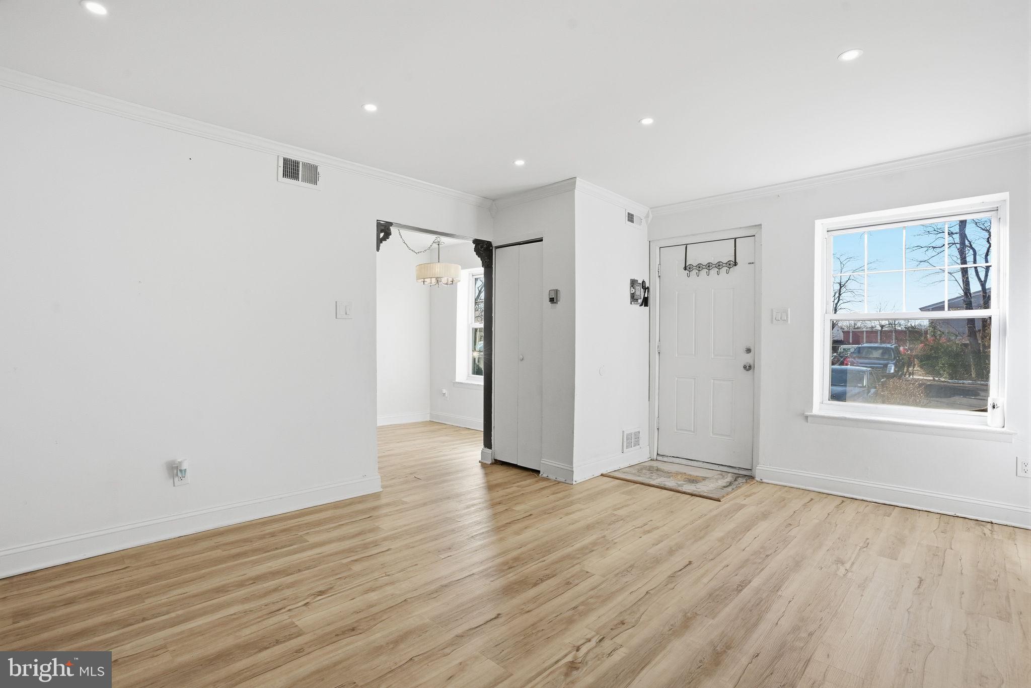 12135 Academy Road, Unit 42 Philadelphia, PA 19154 - Photo 5 of 18 a view of an empty room with wooden floor and a window