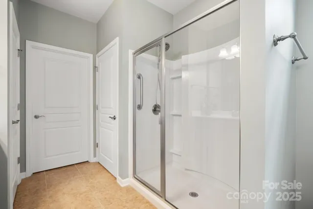 a bathroom with a shower and a glass door