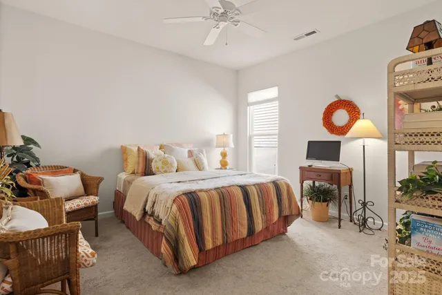 a bedroom with bed and a chandelier