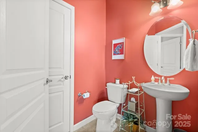 a bathroom with a sink mirror and toilet
