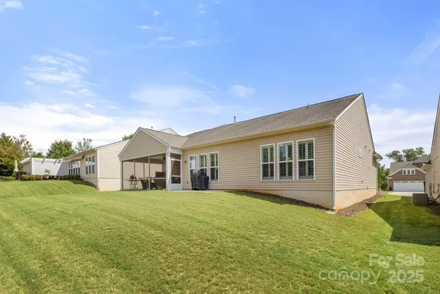 a view of a house with a big yard and large trees