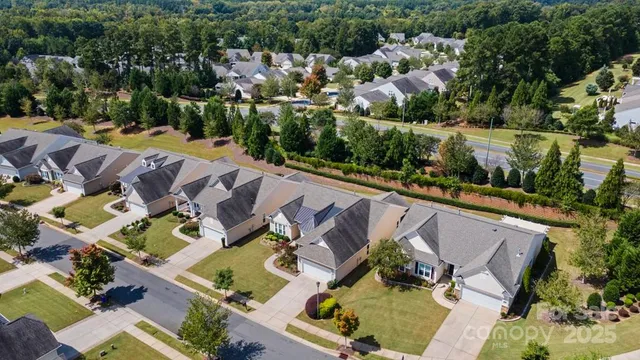 an aerial view of a house with a yard basket ball court and outdoor seating