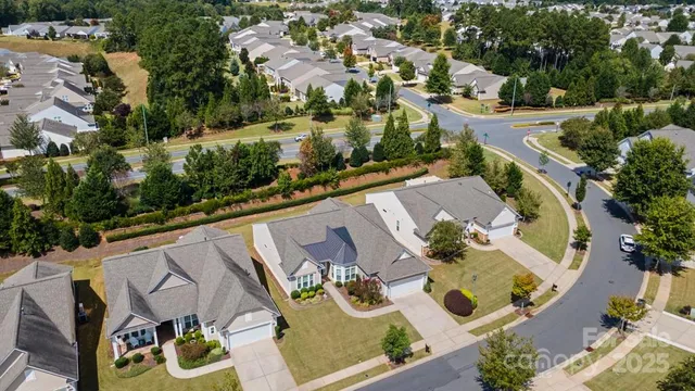 an aerial view of house with yard swimming pool and outdoor seating