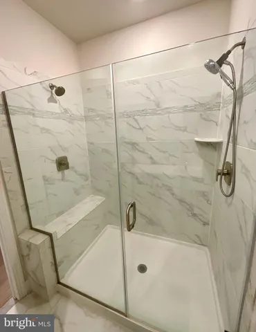a bathroom with a bath tub with a shower