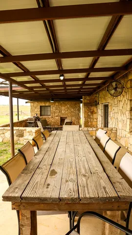 a view of a patio with couches chairs and potted plants