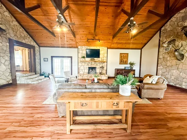 a large kitchen with stainless steel appliances and large windows