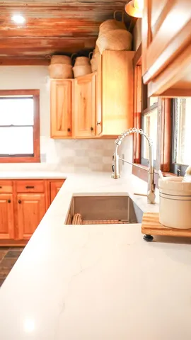 a view of a kitchen with a sink and a large window