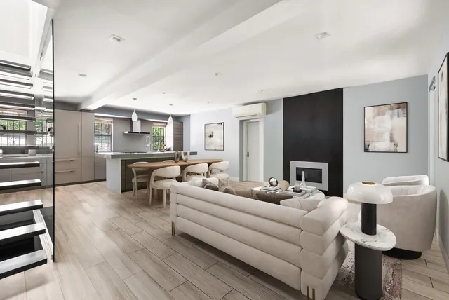 a living room with furniture kitchen view and a wooden floor