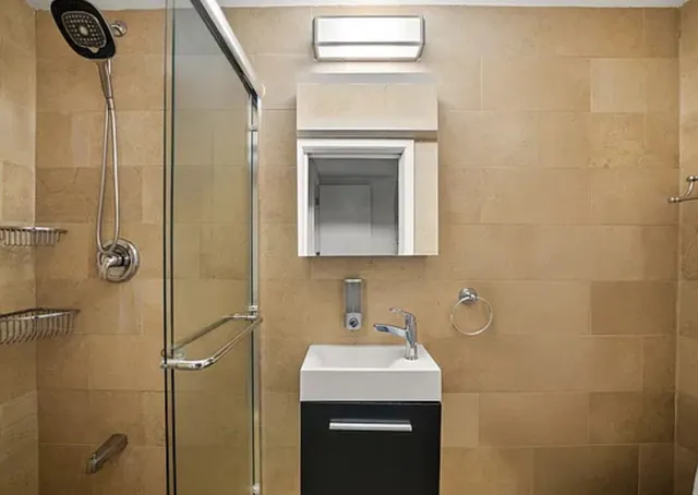 a bathroom with a sink a toilet and shower