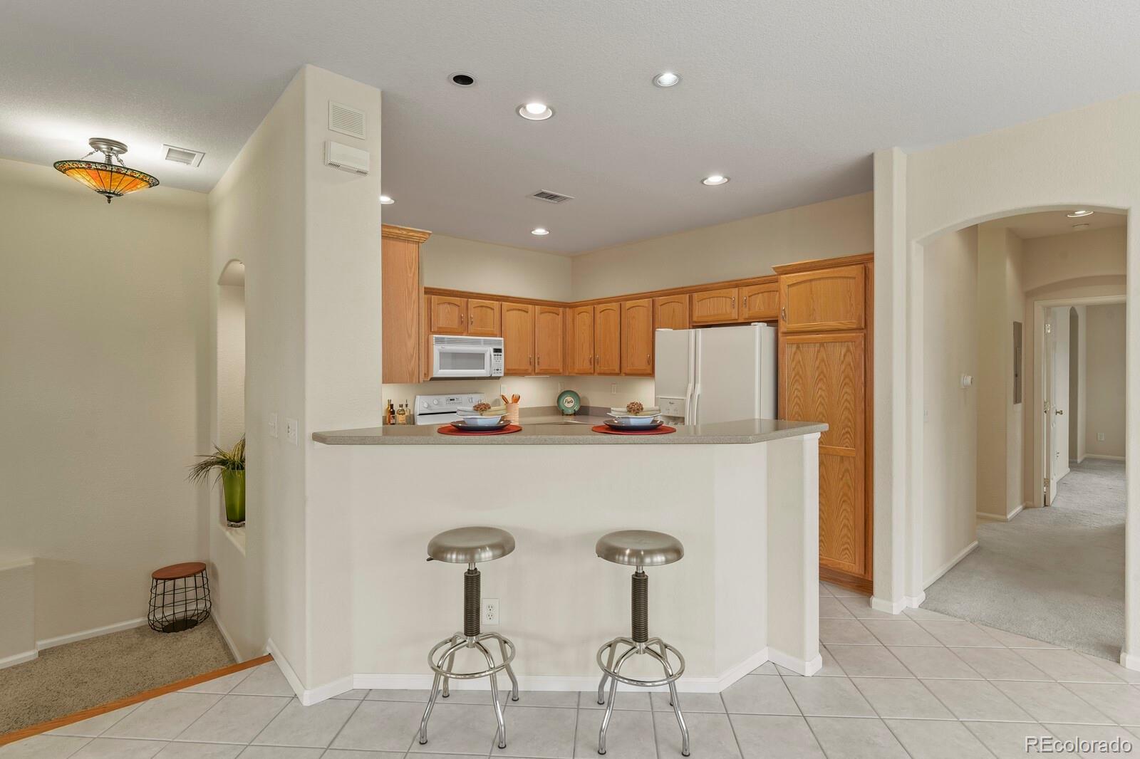 152 Whitehaven Circle Highlands Ranch, CO 80129 - Photo 11 of 25 a view of kitchen with stainless steel appliances granite countertop refrigerator and chair