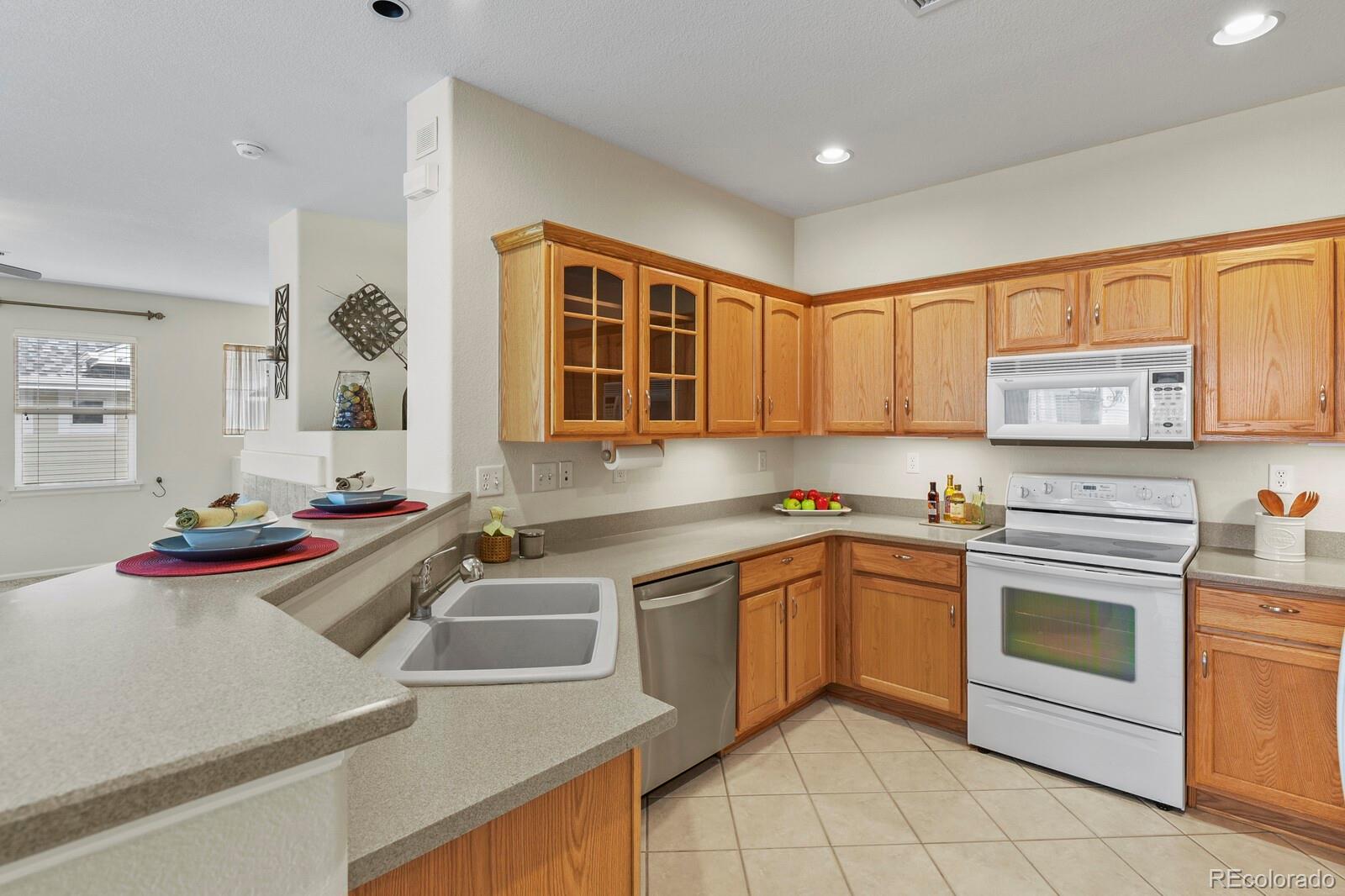 152 Whitehaven Circle Highlands Ranch, CO 80129 - Photo 12 of 25 a kitchen with a sink stove and cabinets