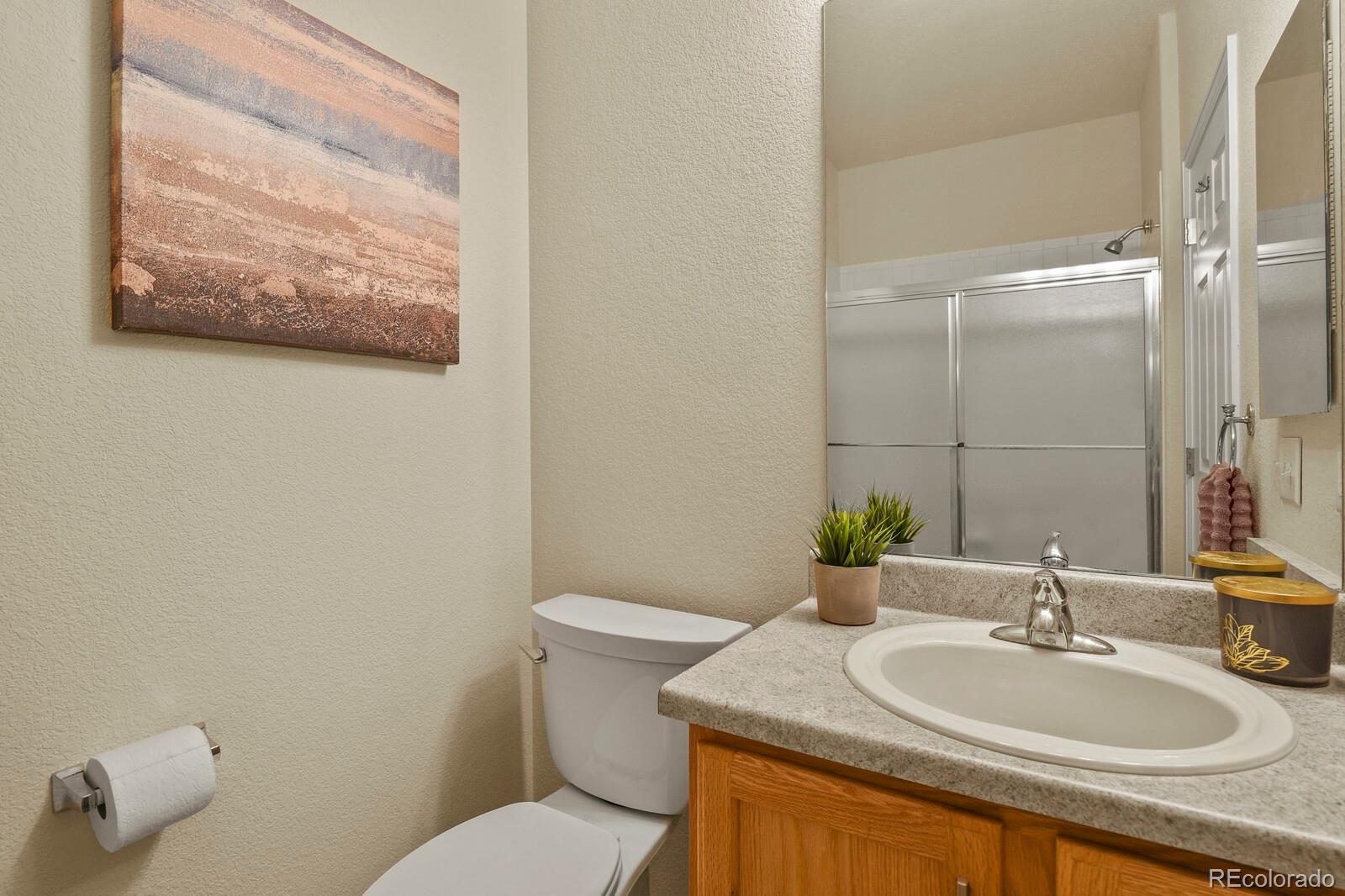 152 Whitehaven Circle Highlands Ranch, CO 80129 - Photo 23 of 25 a bathroom with a granite countertop sink and a mirror