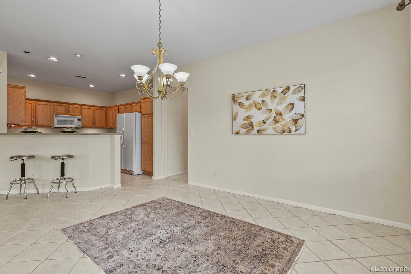 152 Whitehaven Circle Highlands Ranch, CO 80129 - Photo 6 of 25 a view of a kitchen with a refrigerator and a sink