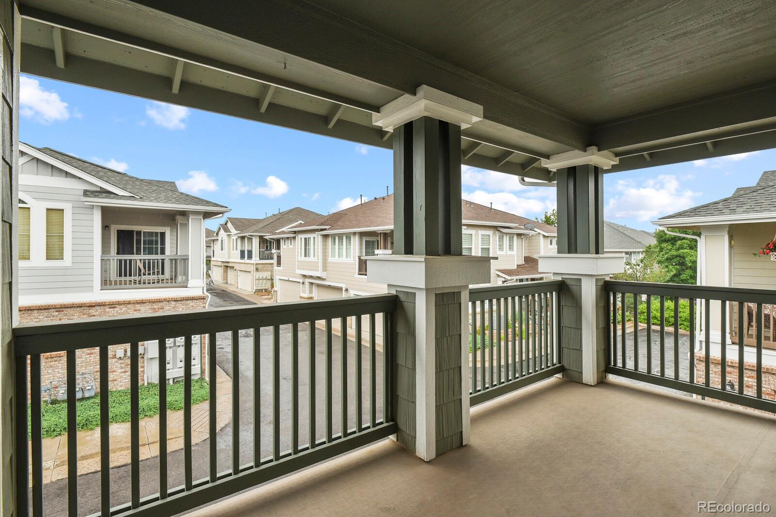 152 Whitehaven Circle Highlands Ranch, CO 80129 - Photo 8 of 25 a view of a porch with a floor to ceiling window and wooden floor