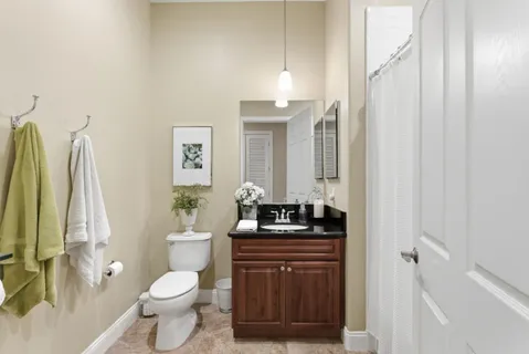 a bathroom with a toilet sink and mirror