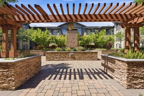 a view of a patio with table and chairs potted plants