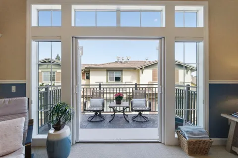 a view of a patio with dining table and chairs
