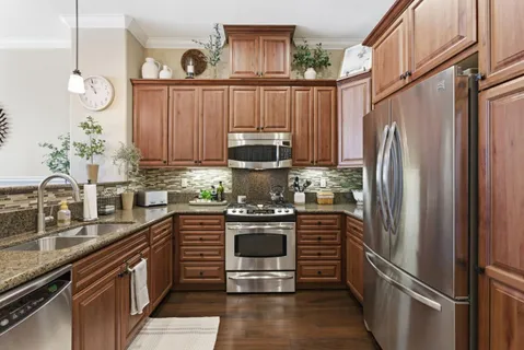 a kitchen with stainless steel appliances a refrigerator sink and stove