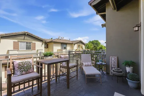 a view of a patio with table and chairs and potted plants