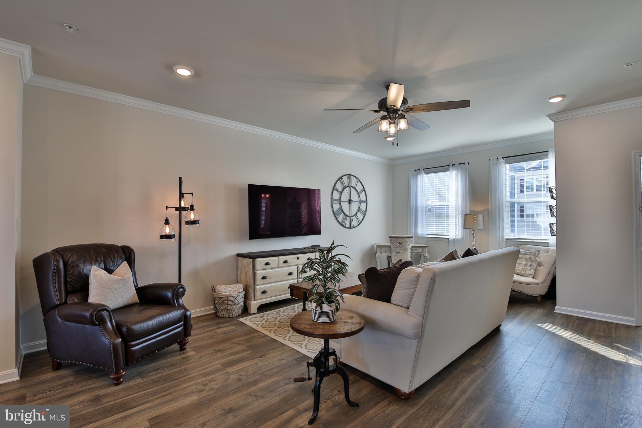 5059 Silver Oak Drive Rosedale, MD 21237 - Photo 11 of 43 a living room with furniture a fireplace and a flat screen tv
