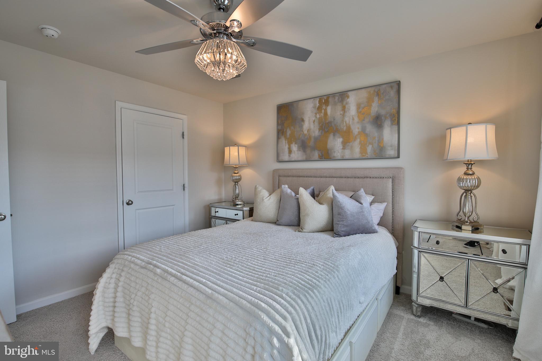 5059 Silver Oak Drive Rosedale, MD 21237 - Photo 16 of 43 a bedroom with a bed and a chandelier