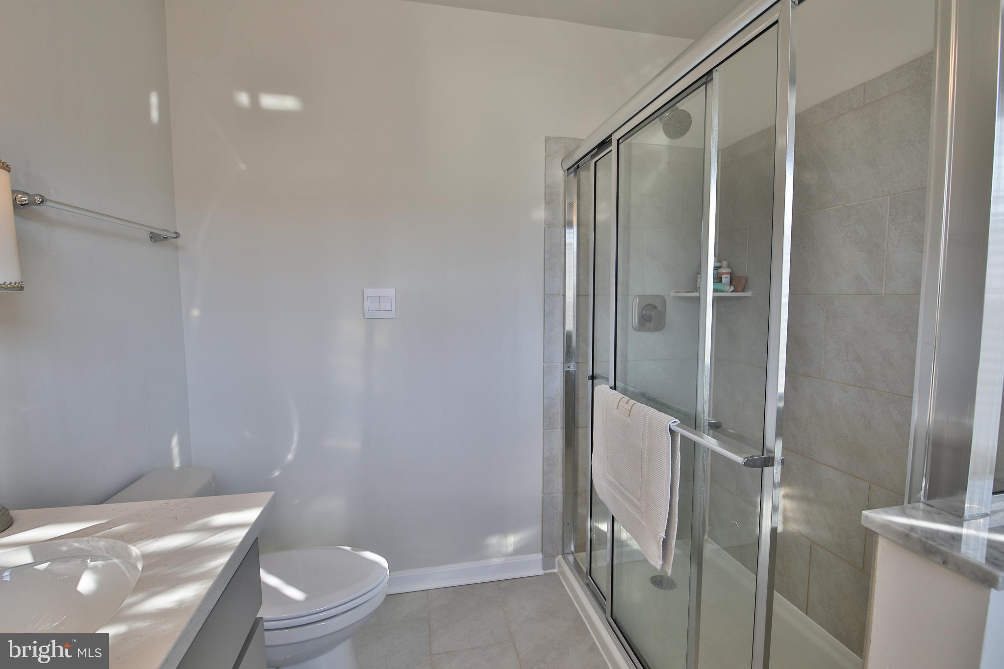 5059 Silver Oak Drive Rosedale, MD 21237 - Photo 17 of 43 a bathroom with a shower and a toilet