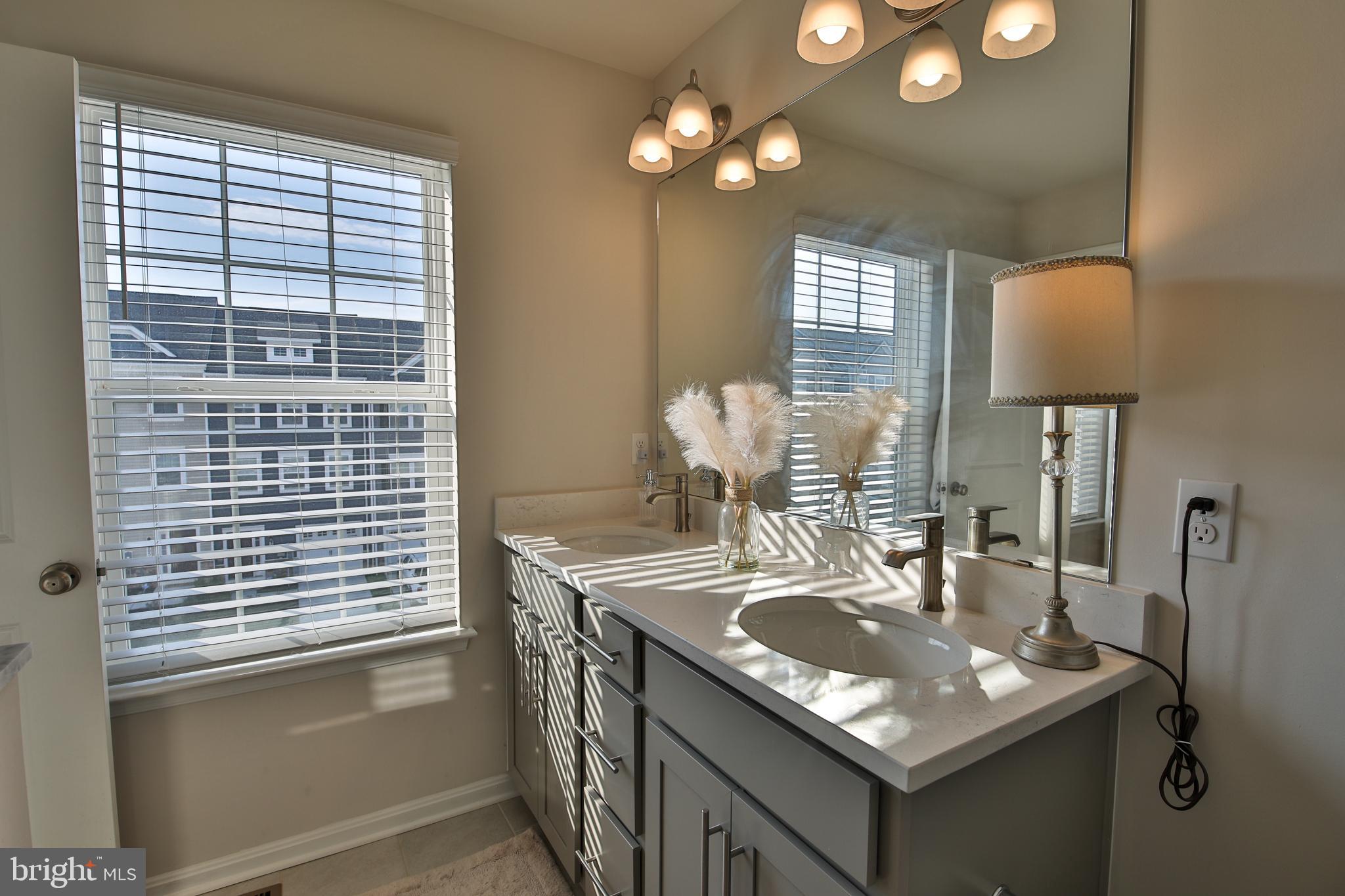 5059 Silver Oak Drive Rosedale, MD 21237 - Photo 18 of 43 a bathroom with a sink a vanity and a large mirror