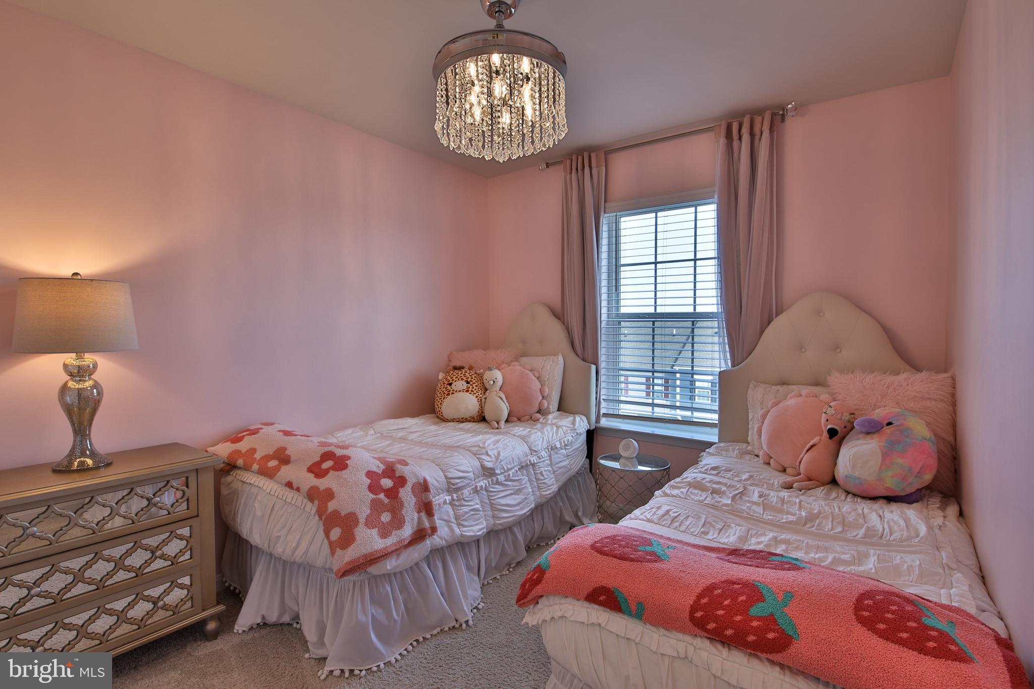 5059 Silver Oak Drive Rosedale, MD 21237 - Photo 19 of 43 a bedroom with two beds and a chandelier