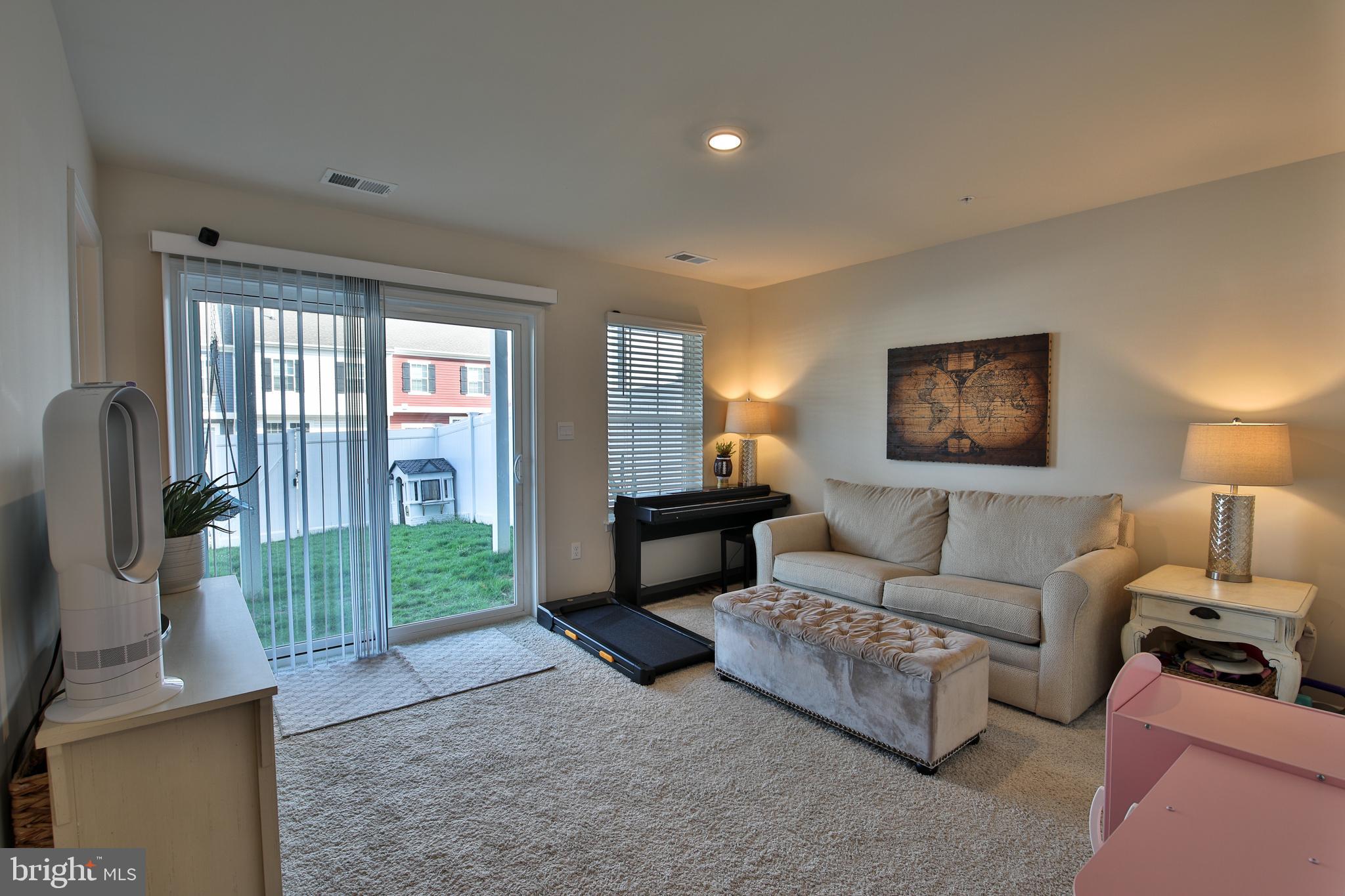 5059 Silver Oak Drive Rosedale, MD 21237 - Photo 27 of 43 a living room with furniture and a flat screen tv