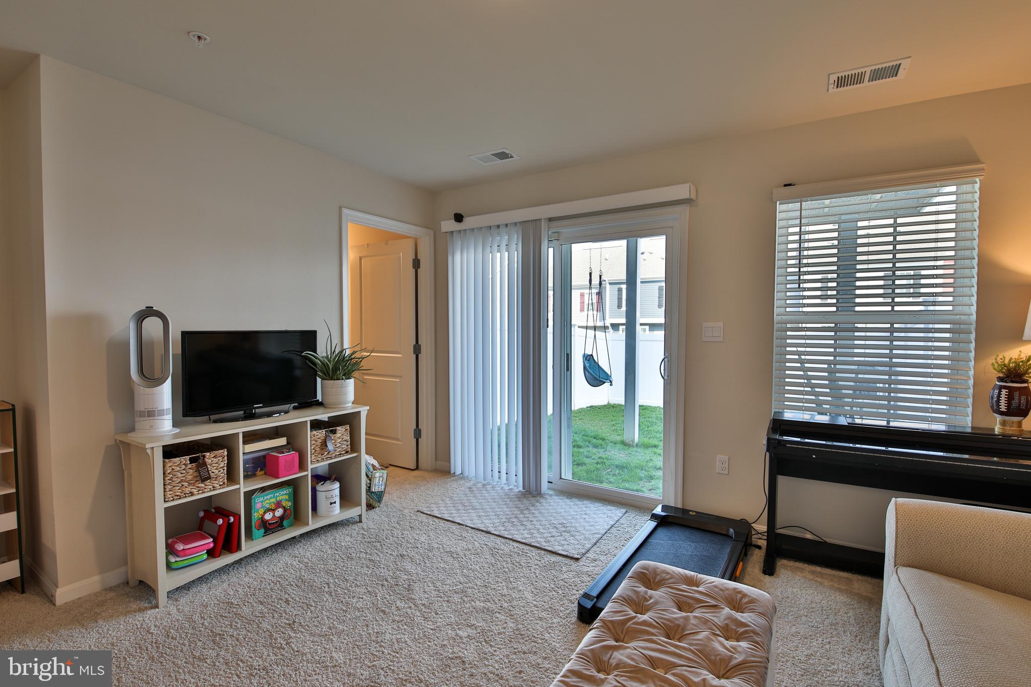 5059 Silver Oak Drive Rosedale, MD 21237 - Photo 30 of 43 a living room with furniture and a flat screen tv