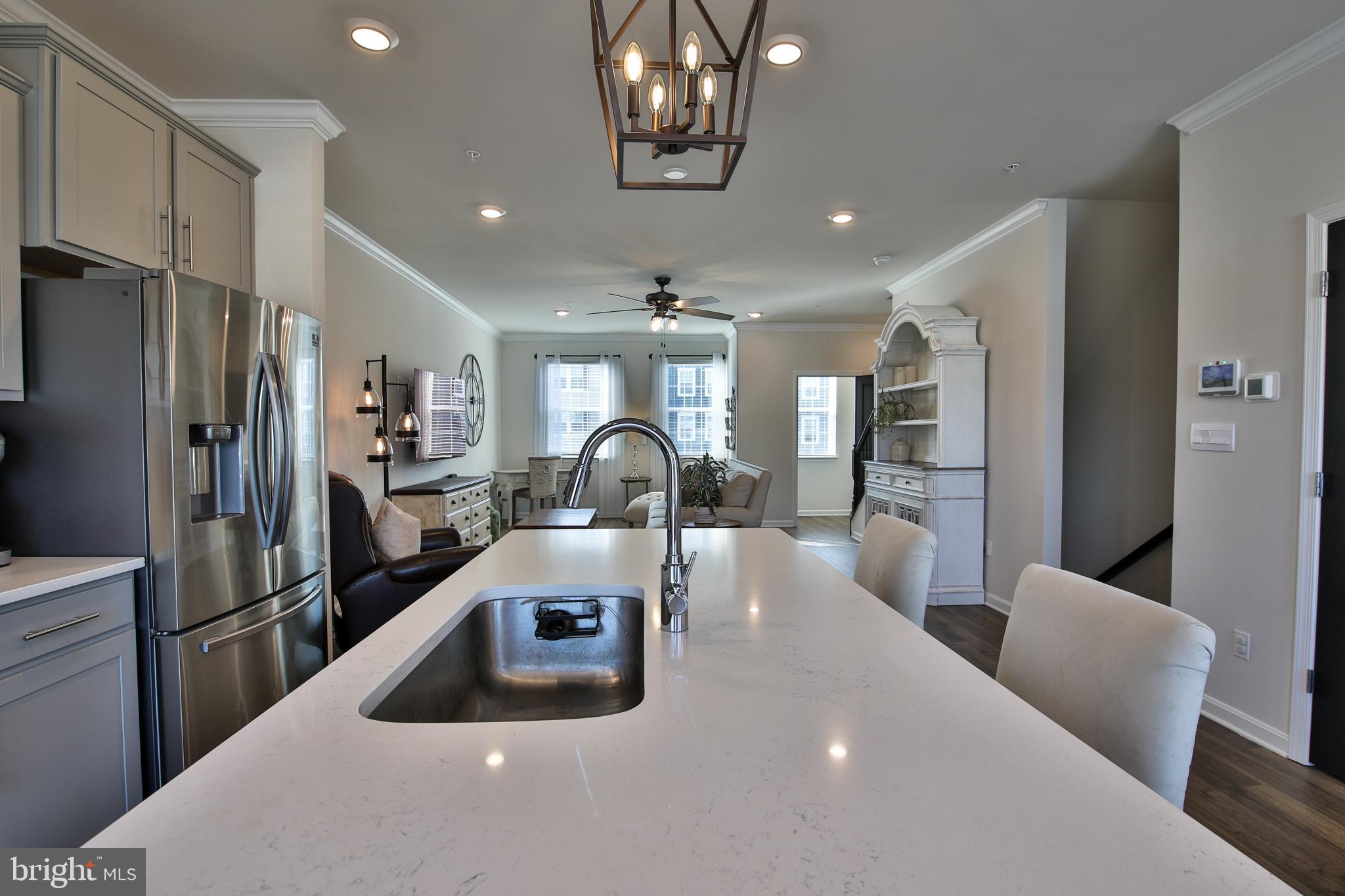 5059 Silver Oak Drive Rosedale, MD 21237 - Photo 5 of 43 a kitchen with stainless steel appliances a refrigerator a sink a stove a dining table and chairs