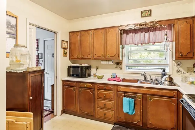 a kitchen with stainless steel appliances a sink stove and refrigerator