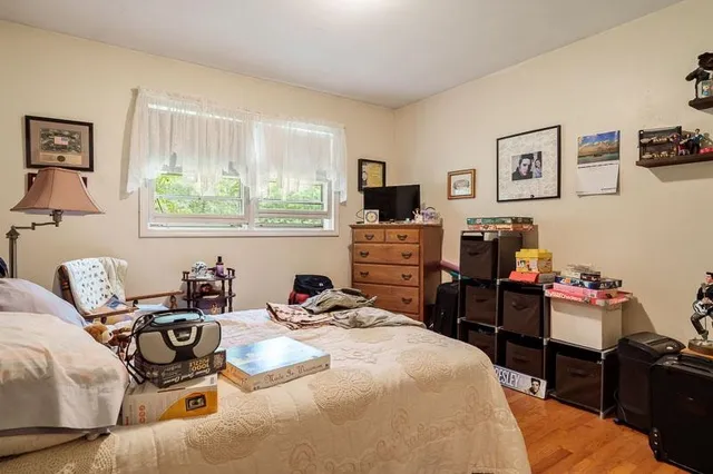 a bedroom with a bed and a tv on the dresser