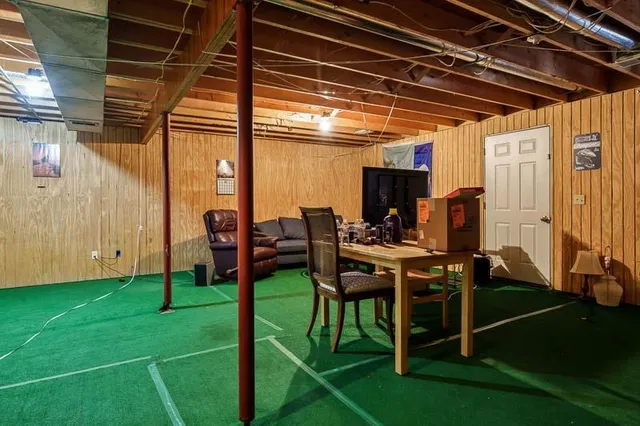 a living room with furniture a wooden floor and next to a window