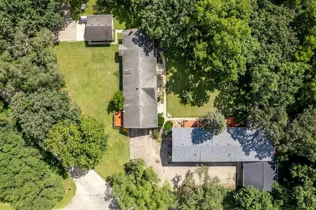 an aerial view of house with yard