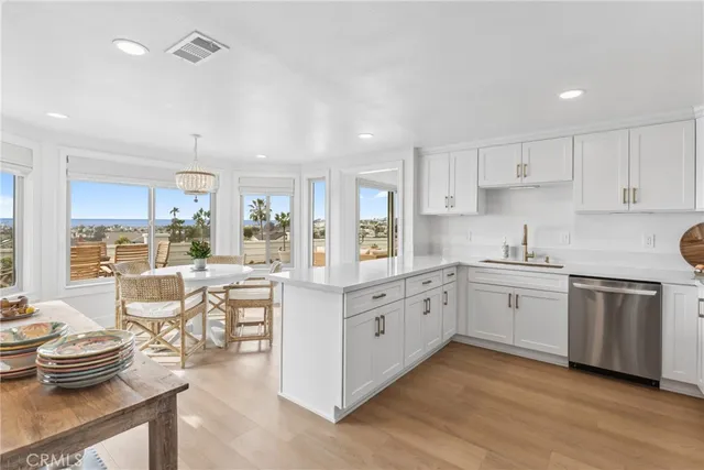 a dining room with furniture and a floor to ceiling window