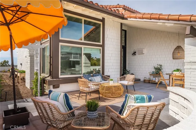 a view of a patio with dining table and chairs