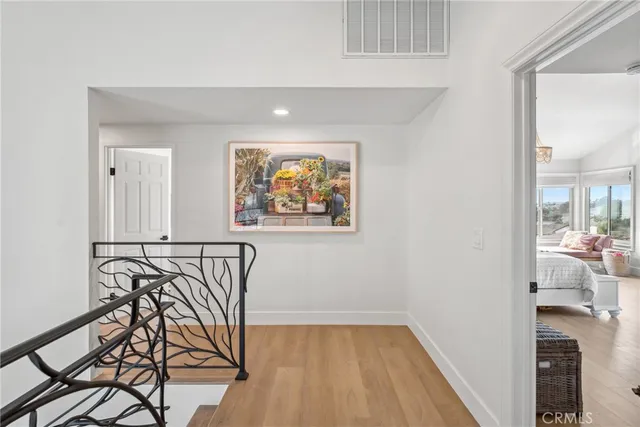 a bedroom with a bed and a painting on the wall