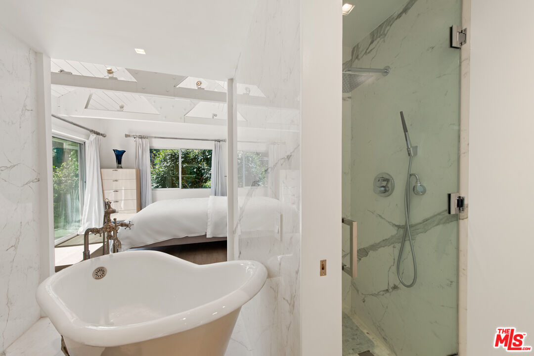 5949 Ramirez Canyon Road Malibu, CA 90265 - Photo 23 of 26 a bathroom with a tub shower and sink