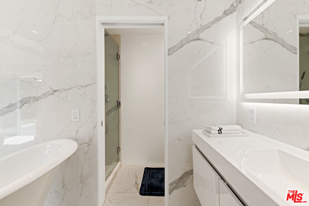 5949 Ramirez Canyon Road Malibu, CA 90265 - Photo 24 of 26 a bathroom with a sink a vanity and a bathtub