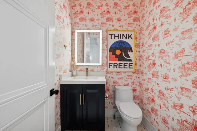 a living room with furniture and a view of kitchen