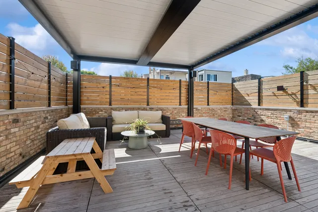 a outdoor dining space with furniture and wooden floor