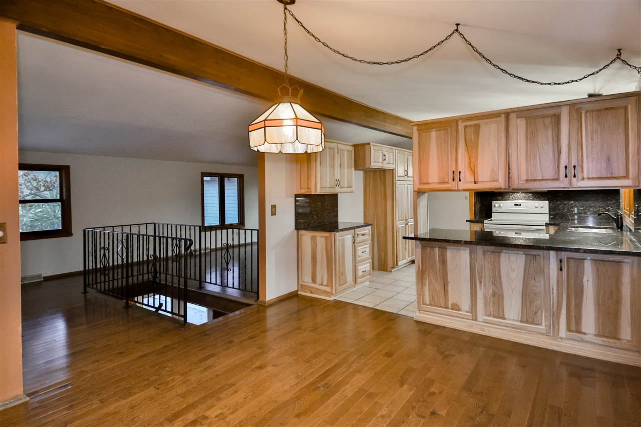 118 North Elizabeth Scales Mound Road Elizabeth, IL 61028 - Photo 17 of 40 a view of a kitchen with wooden floor and a window